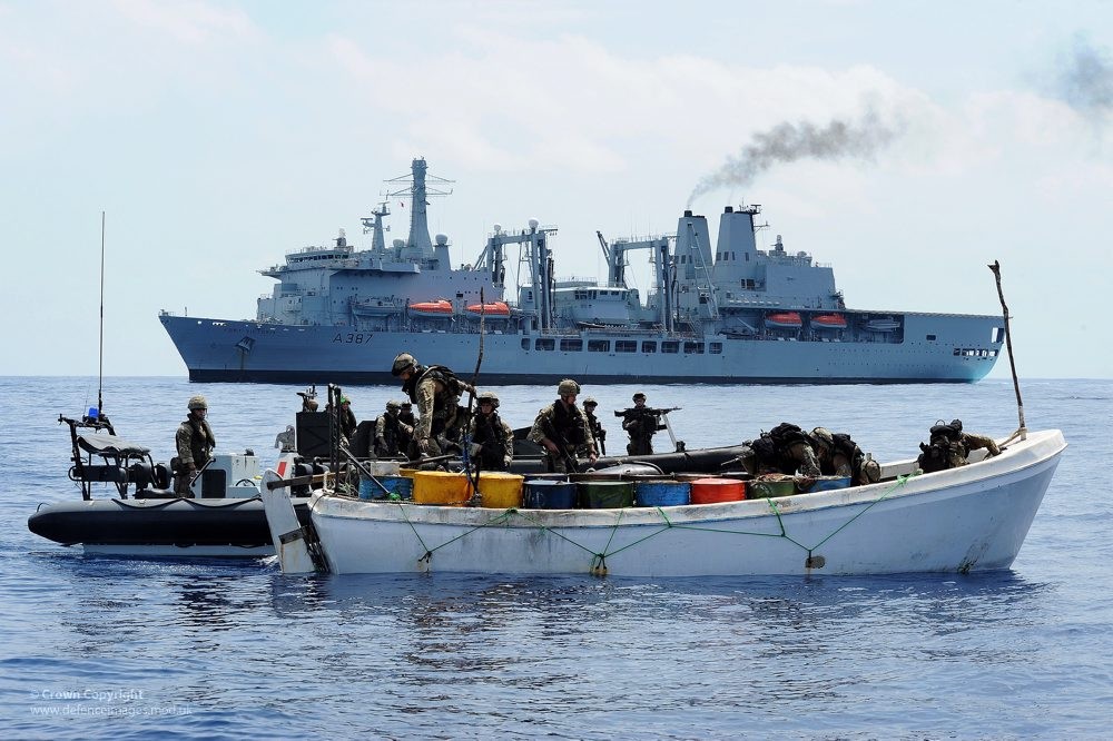 Personnel from RFA Fort Victoria Board a Boat Suspected of Use by Pirates Near Somalia Royal Navy and Royal Marines Commandos board a Somalian whaler suspected of being operated by pirates in the Indian Ocean off the Horn of Africa.
The Royal Navy has struck at the heart of Somali piracy operating in the Somali basin. RFA Fort Victoria was patrolling in an area approximately 420 nautical miles from the Seychelles and 350 nautical miles from the Somali coast as part of NATO s combined task force 508.
Early that morning, she received information that a Spanish fishing vessel operating to the north of their position had come under attack from a group of pirate vessels to the North of their position. The ship s Lynx helicopter was quickly despatched to investigate.
Once at the scene, the helicopter identified two suspect vessels, a whaler and a skiff, in the vicinity of the fishing vessel. The faster of the two, a skiff, sped away at over 25 knots as the helicopter gave chase. When the skiff ignored orders to stop, a specially trained sniper onboard the Lynx helicopter fired warning shots ahead of the fleeing vessel which stopped and the suspected pirates onboard were then transferred to Fort Victoria via boat.
Fort Victoria s Royal Marines boarding team then boarded the whaler and another skiff in the vicinity. As a result of the day s action, a total of seven suspected pirates were detained onboard Fort Victoria along with their whaler as evidence, with no injuries being sustained by either side.
Photographer: LA(Phot) Dave Jenkins
Image 45153434.jpg from www.defenceimages.mod.uk
For latest news visit: <a href="http://www.mod.uk" rel="nofollow">www.mod.uk</a>
Follow us:
<a href="http://www.facebook.com/defenceimages" rel="nofollow">www.facebook.com/defenceimages</a>
<a href="http://www.twitter.com/defenceimages" rel="nofollow">www.twitter.com/defenceimages</a>
